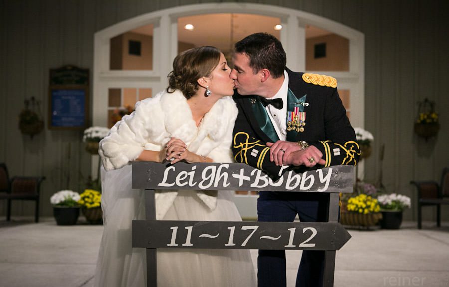 Downingtown Country Club wedding couple poses outside of golf club for their wedding photographers