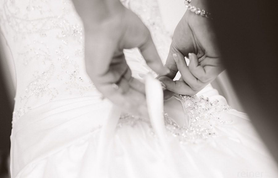 bridesmaids helping bride into her dress - Allentown PA wedding photos by Reiner Photography