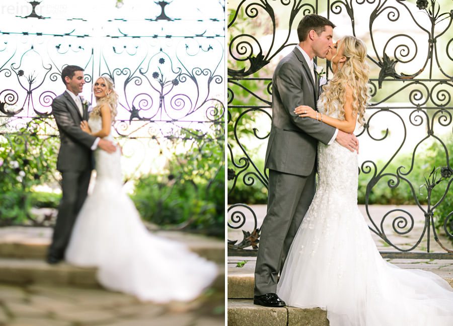 bride and groom in from of iron gate