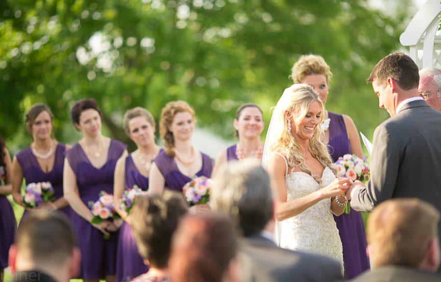 bride and groom exchange rings at their wedding ceremony