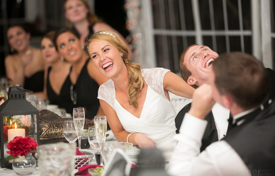 bride and bridal party react to projection during their wedding reception