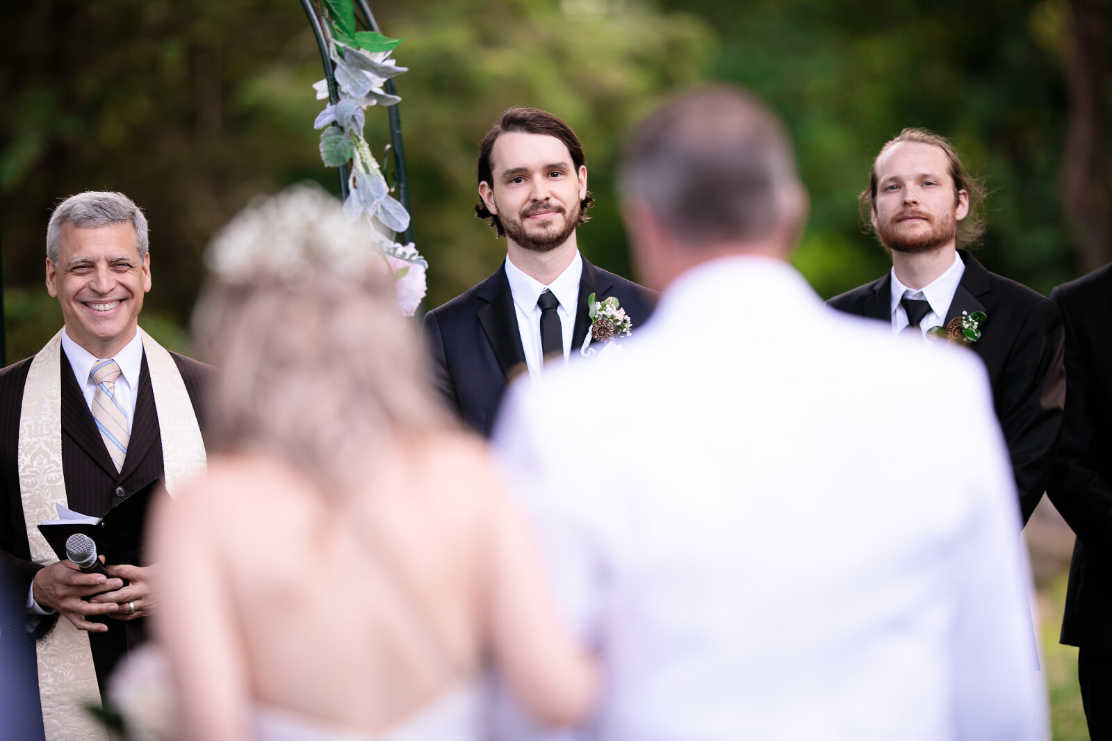 groom watches nervously as his bride is walked into the wedding ceremony at Glen Foerd