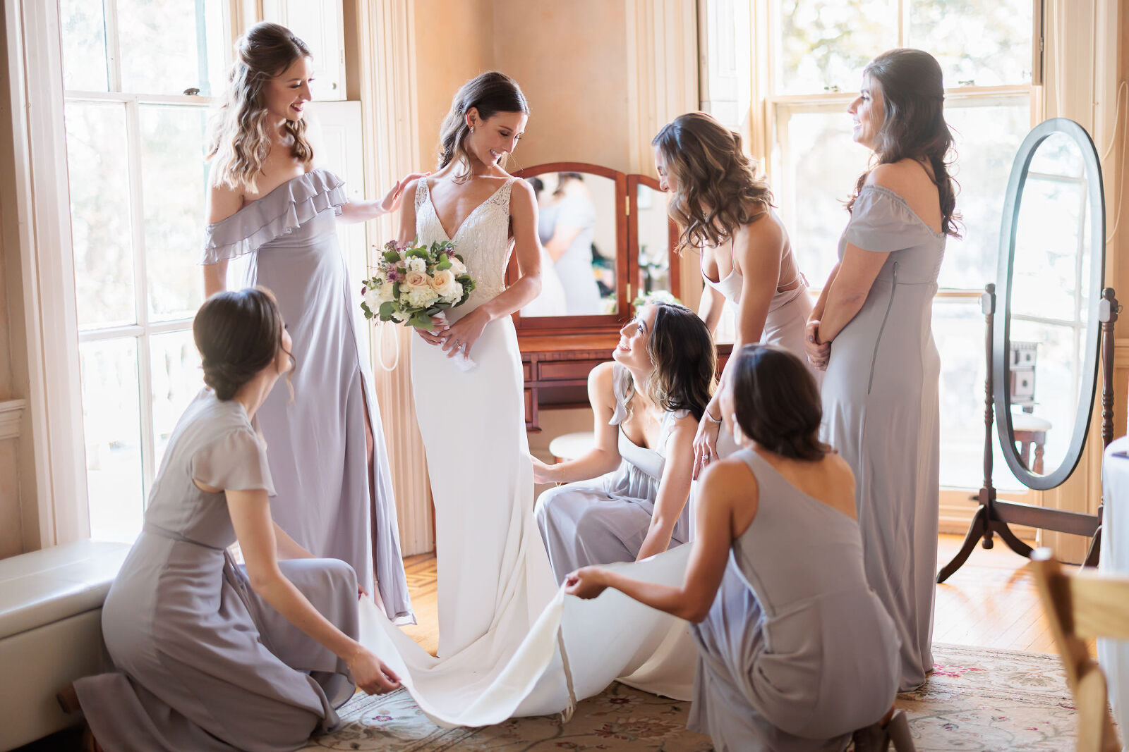 Bridesmaids help bride get ready for her Wedding at Glen Foerd in bridal suite