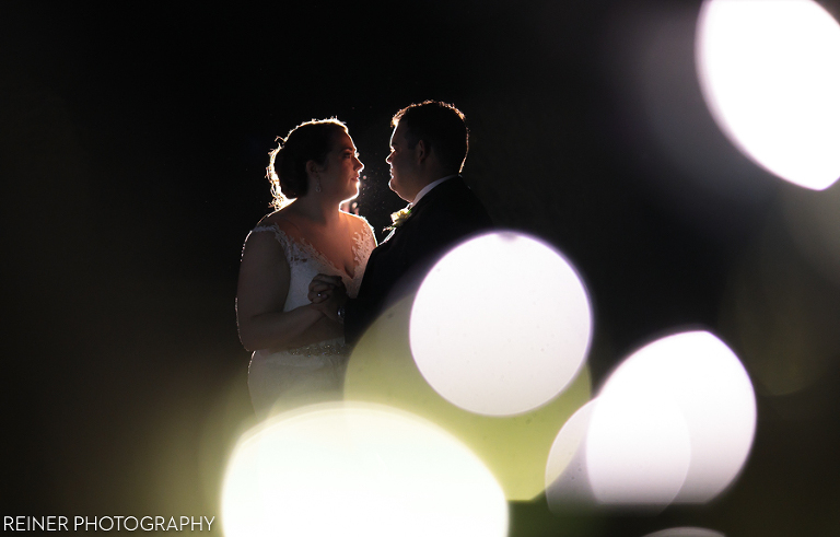 bride and groom in front of Warrington Country Club at night