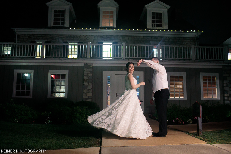 bride and groom at night dancing in front of Downingtown Country Club Wedding