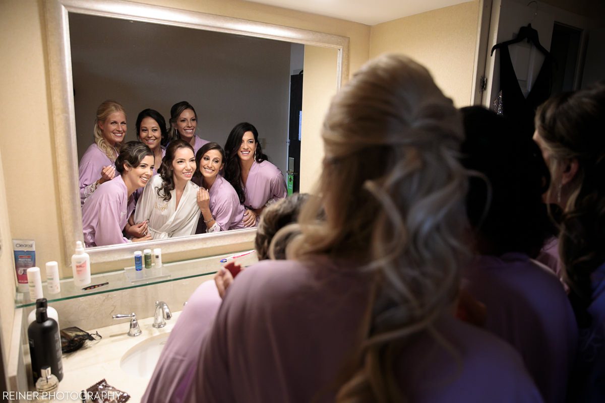 bridesmaids looking into mirror