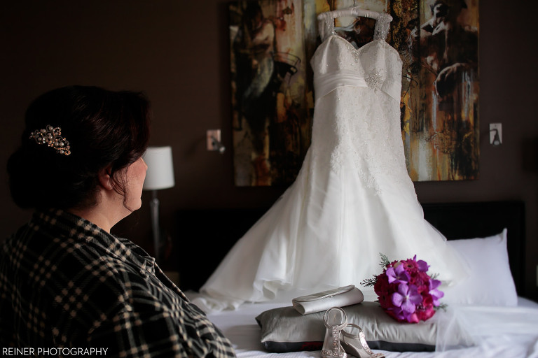 bride looking at wedding dress