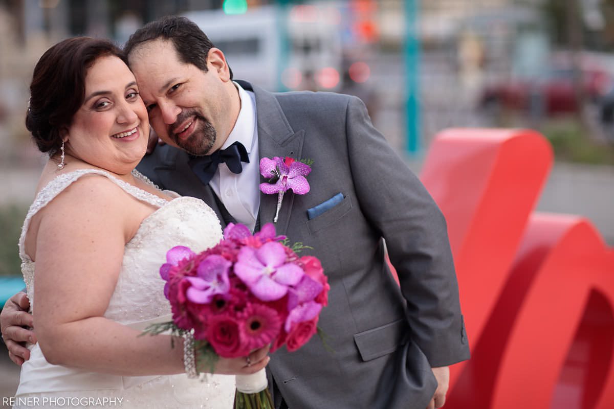 wedding photos near small LOVE statue